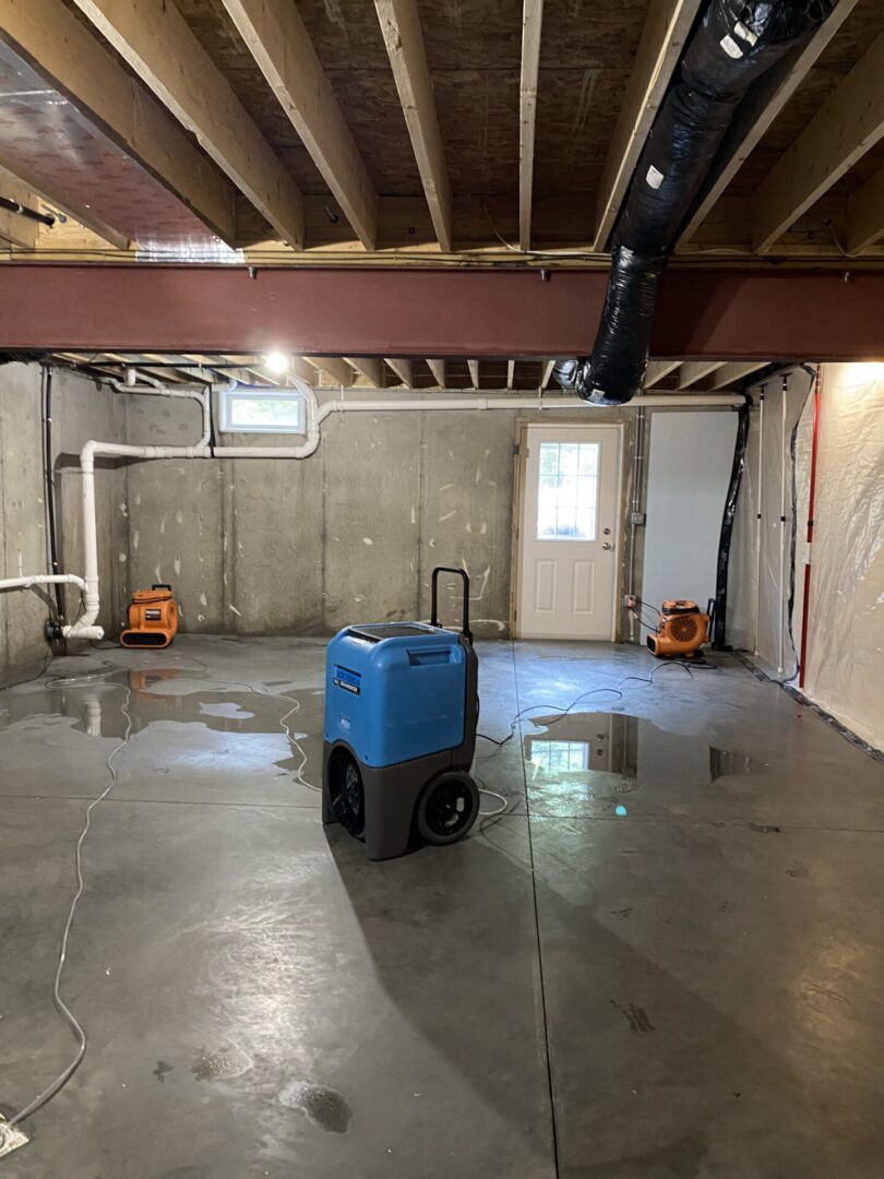 A room with water damage and a blue cooler